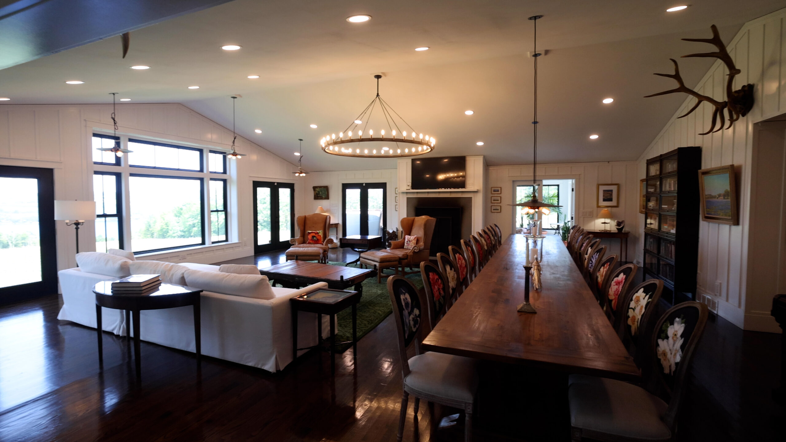 Great room with fireplace and long dining table