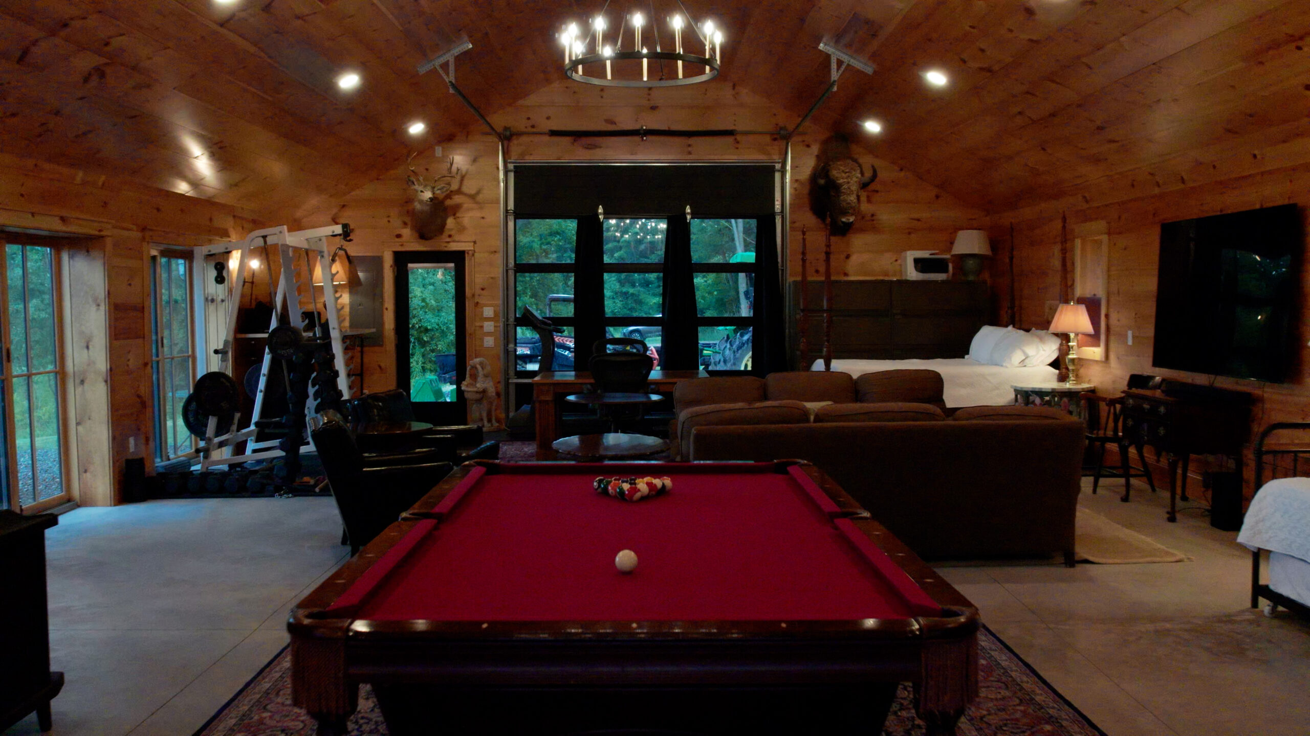 Warm wood lodge with billiards table and guest sleeping area